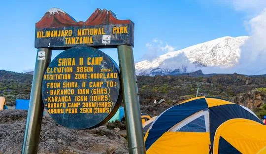 Shira 2 Camp signboard with tents below Kibo